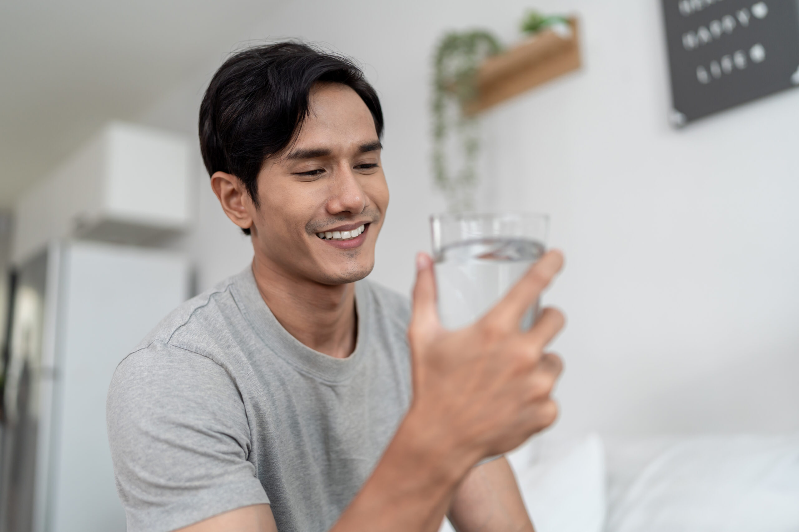 Homeowner enjoying a glass of clean filtered water